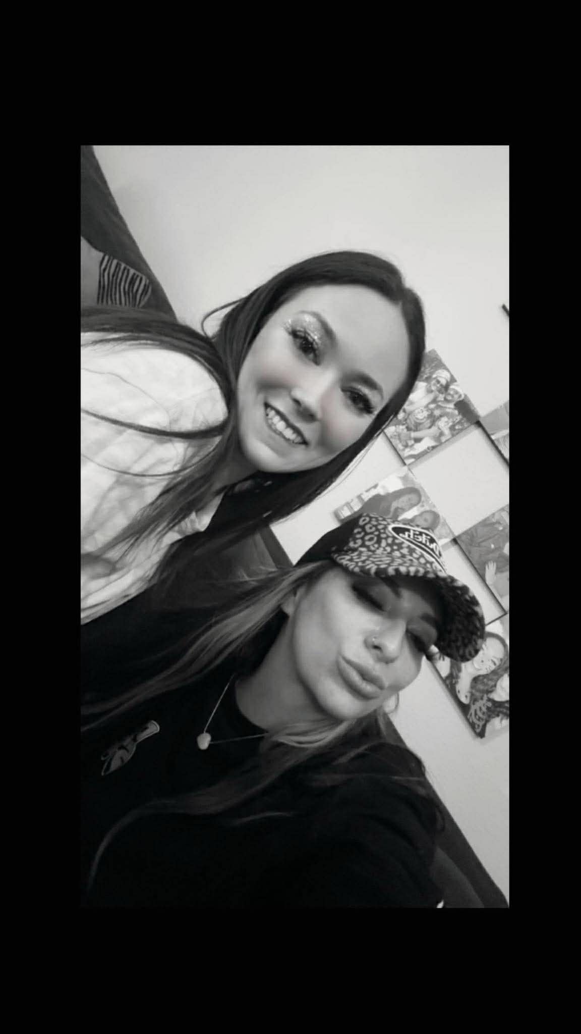 The duo in a black-and-white heavy-bordered shot, leopard cap on the blonde, glamorous.